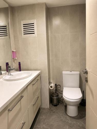 a bathroom with a white toilet and a sink at CİTY HOME tüyap in Esenyurt