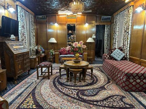 a living room with a couch and a table at Houseboat Saleem in Dal Lake