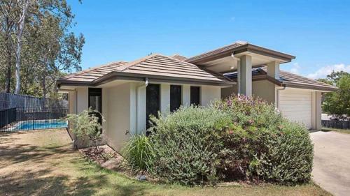 a small house with a fence in front of it at Hideaway -4BR Family Home with Pool, Near Beach in Caloundra