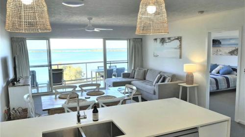 a living room with a view of the ocean at The Moorings Unit 508 in Golden Beach