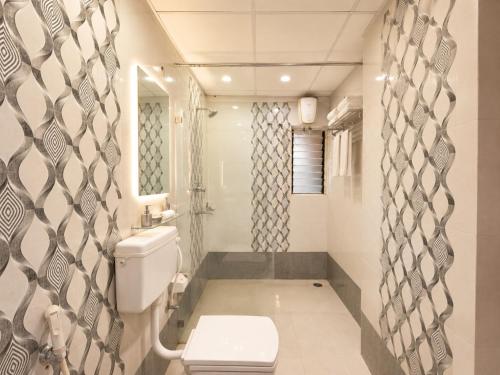 a bathroom with a toilet and a sink at BEN-SEN Puri #Affordable # S-Pool in Puri