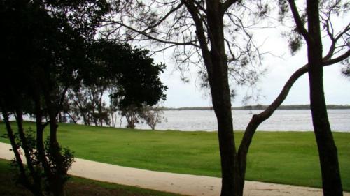 a view of a field of grass and a body of water at Windbourne Unit 8 in Golden Beach