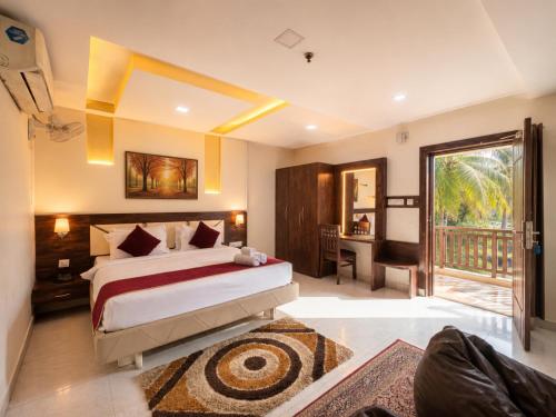 a bedroom with a bed and a balcony at BEN-SEN Puri #Affordable # S-Pool in Puri