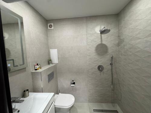 a bathroom with a shower and a toilet and a sink at View of the forest in Veliko Tŭrnovo