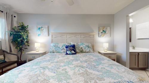a bedroom with a large bed with two night stands at Summit 1013 in Panama City Beach