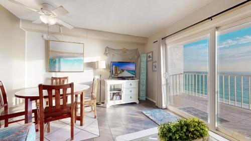 a dining room with a view of the ocean at Summit 1013 in Panama City Beach