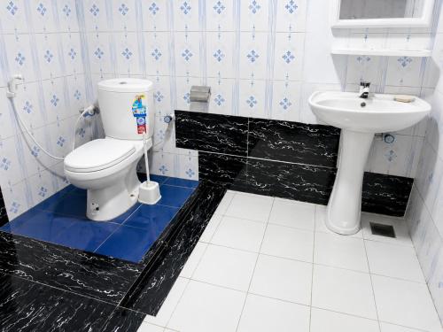a bathroom with a toilet and a sink at A to Z surf camp in Arugam Bay