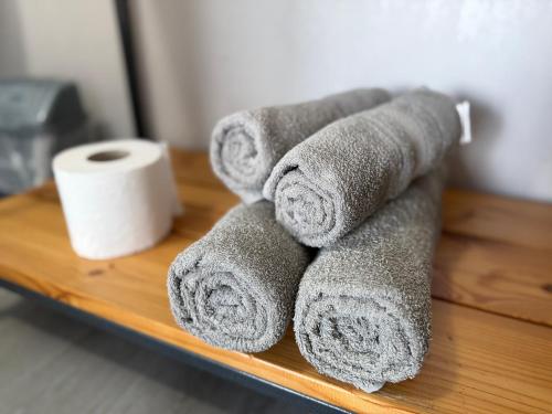 a pile of towels and a roll of toilet paper at Hotel Loft Кароліно-Бугаз in Zatoka