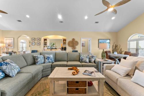 a living room with a couch and a table at Gulf View Beach Home with Pool in Gulf Shores