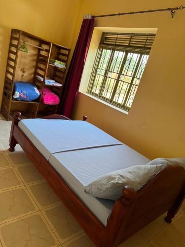 a bedroom with a bed in a room with a window at Binga villa in Kisoro