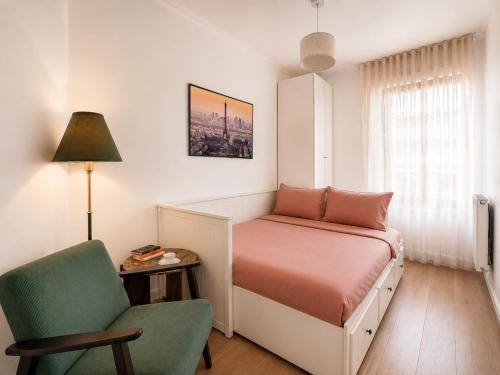 a bedroom with a bed and a chair and a lamp at Bright & Spacious Apartment near Paris 6 Guests in Clichy