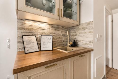 a kitchen with a sink and wooden counter top at Bright & Spacious Apartment near Paris 6 Guests in Clichy