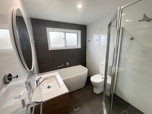 a bathroom with a sink and a toilet and a shower at Wenlaw Cottage Rear Hat Head - Bring your own linen. in Hat Head