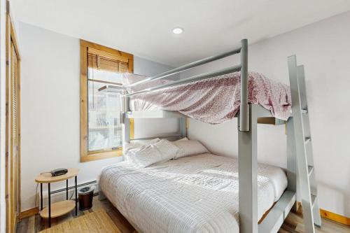 a bedroom with a bunk bed with a ladder at Main Street Station #2302 in Breckenridge