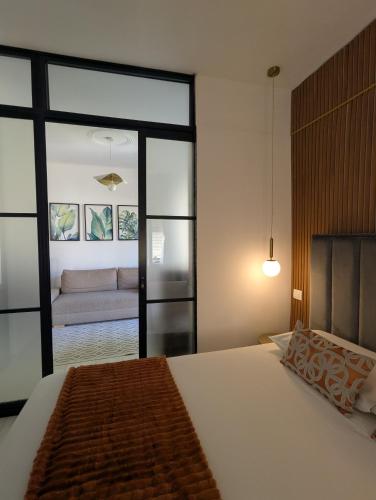 a bedroom with a bed and a living room with a couch at Casa Moret in Sanremo