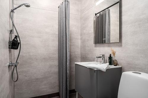 a bathroom with a shower and a sink at Stora Hotellet Markaryd in Markaryd