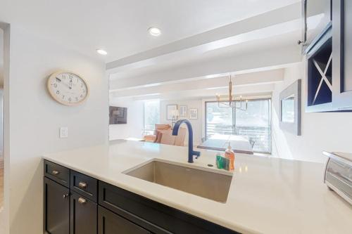 a kitchen with a sink and a clock on the wall at Vail International 204 in Vail