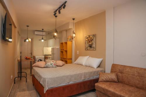 a small bedroom with a bed and a couch at Cozy Twins - Petra in Kavála
