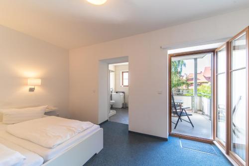a bedroom with a bed and a balcony at Gästehaus Am Hothertor in Görlitz
