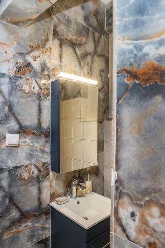 a bathroom with a sink and a mirror at Cozy Twins - Petra in Kavála