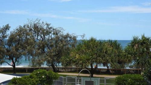 a view of the beach from the balcony of a resort at Rolling Surf Resort Unit 48 in Caloundra