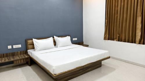 a bed with white sheets and pillows in a room at Nal Village Resort By Explore With Nirav in Rupāwati
