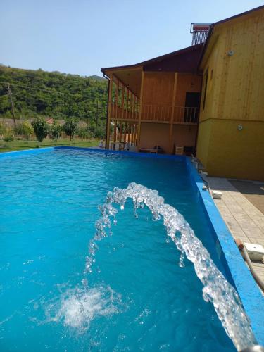 a water fountain in a swimming pool at Ani Center Hotel in Dovekh
