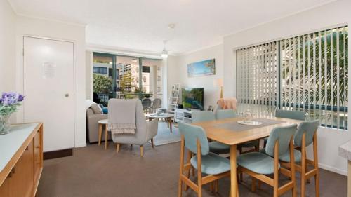 a dining room and living room with a table and chairs at Unit 2 'fair Haven' Kings Beach in Caloundra