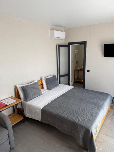 a bedroom with a large bed and a couch at Hotel Loft Кароліно-Бугаз in Zatoka