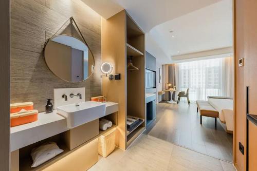 a bathroom with a sink and a mirror at Atour Hotel Altay in Altay