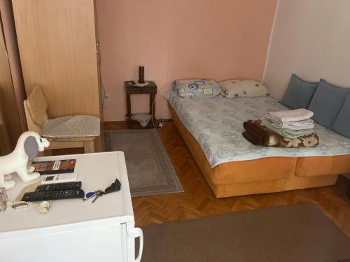 a small room with a bed and a desk at Room with balcony Milan in Herceg-Novi