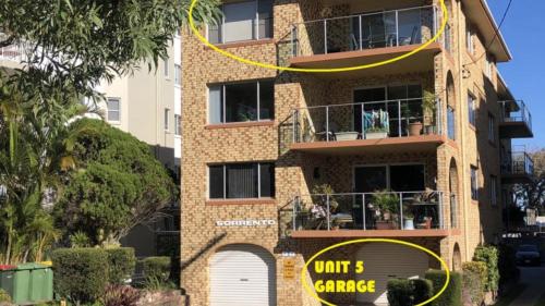 a building with a sign that reads unit garage at Sorrento Unit 5 in Golden Beach