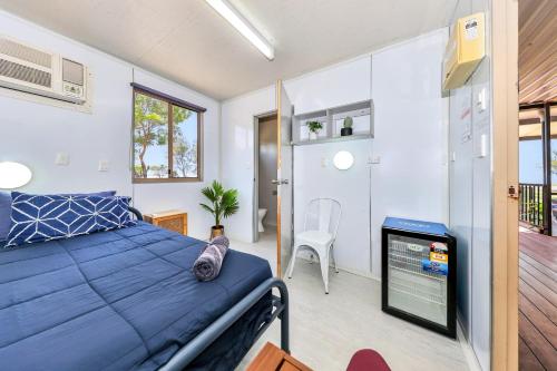 a bedroom with a bed and a tv in it at Skippers at Dundee in Dundee Beach