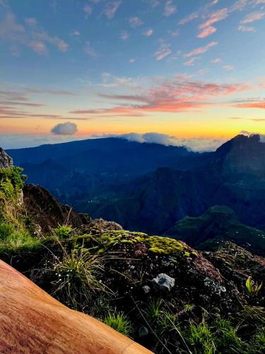 a view from the top of a mountain at sunset at kaz frangipanier in Entre-Deux
