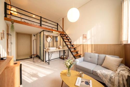 a living room with a loft bed and a couch at Restia Hotel Suwon Station in Suwon