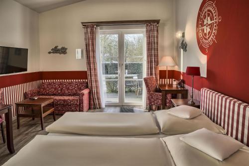 a hotel room with two beds and a living room at Seehotel Frankenhorst - BW Signature Collection in Schwerin
