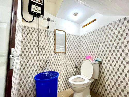 a bathroom with a toilet and a shower at MP Villa Boulvard 43 Malang in Blimbing