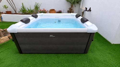 a hot tub sitting on the grass in a yard at Lefko House in Lachania