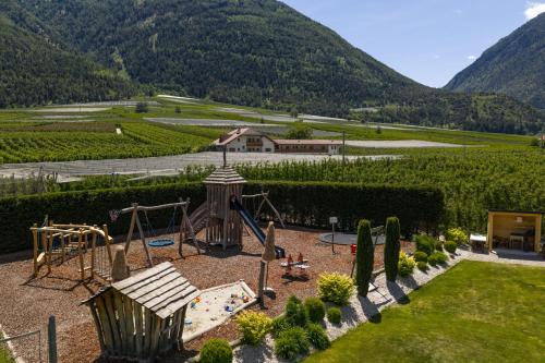 a garden with a playground at Residence Montani in Laces