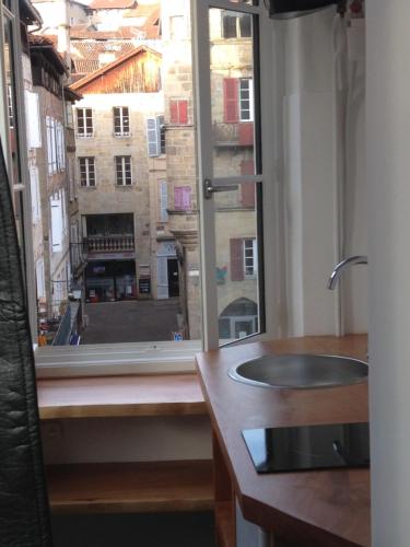 a bathroom with a sink and a window at Studio de la Halle. in Figeac