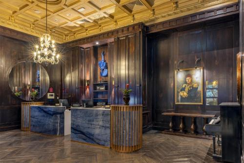 a restaurant with wooden walls and a chandelier at Palazzo Donizetti Istanbul, Tapestry Collection by Hilton in Istanbul