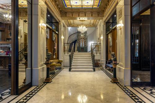 a hallway with a staircase in a building at Palazzo Donizetti Istanbul, Tapestry Collection by Hilton in Istanbul