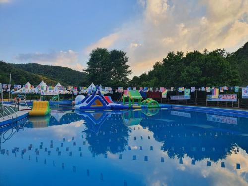 a water park with a pool with slides and rides at Goesan Joryeong Pension in Koesan