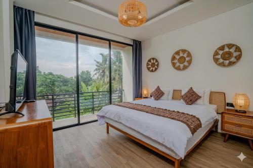 a bedroom with a bed and a large window at Santara Villa Ubud in Ubud