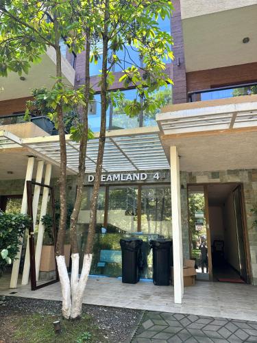 a sign for the entrance to a building with trash cans at Beach Dreamland Oasis in Chakvi
