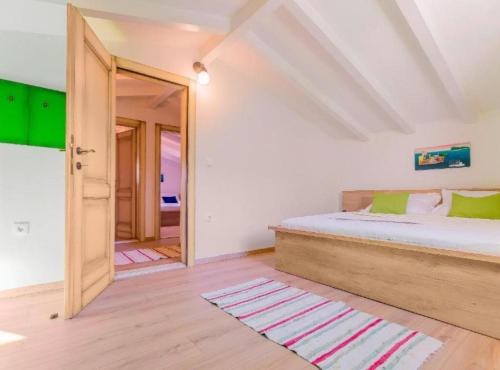 a bedroom with a bed and a open door at Rustic Haven Villa in Vrgorac