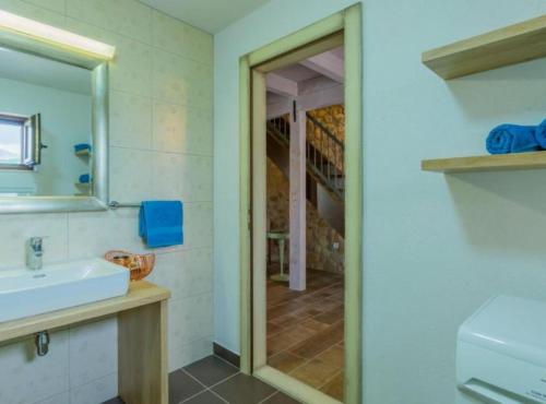 a bathroom with a sink and a mirror at Rustic Haven Villa in Vrgorac