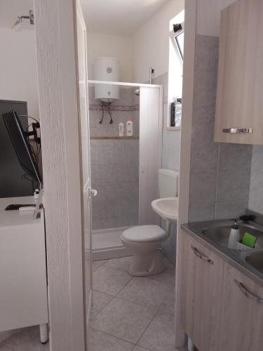 a bathroom with a toilet and a sink at La casetta in Martina Franca
