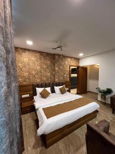 a bedroom with a large bed in a room at Hotel Central Point in Indore
