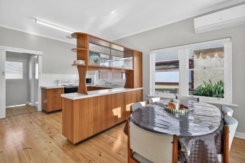 a kitchen and dining room with a table at Hutchinson House in Goolwa